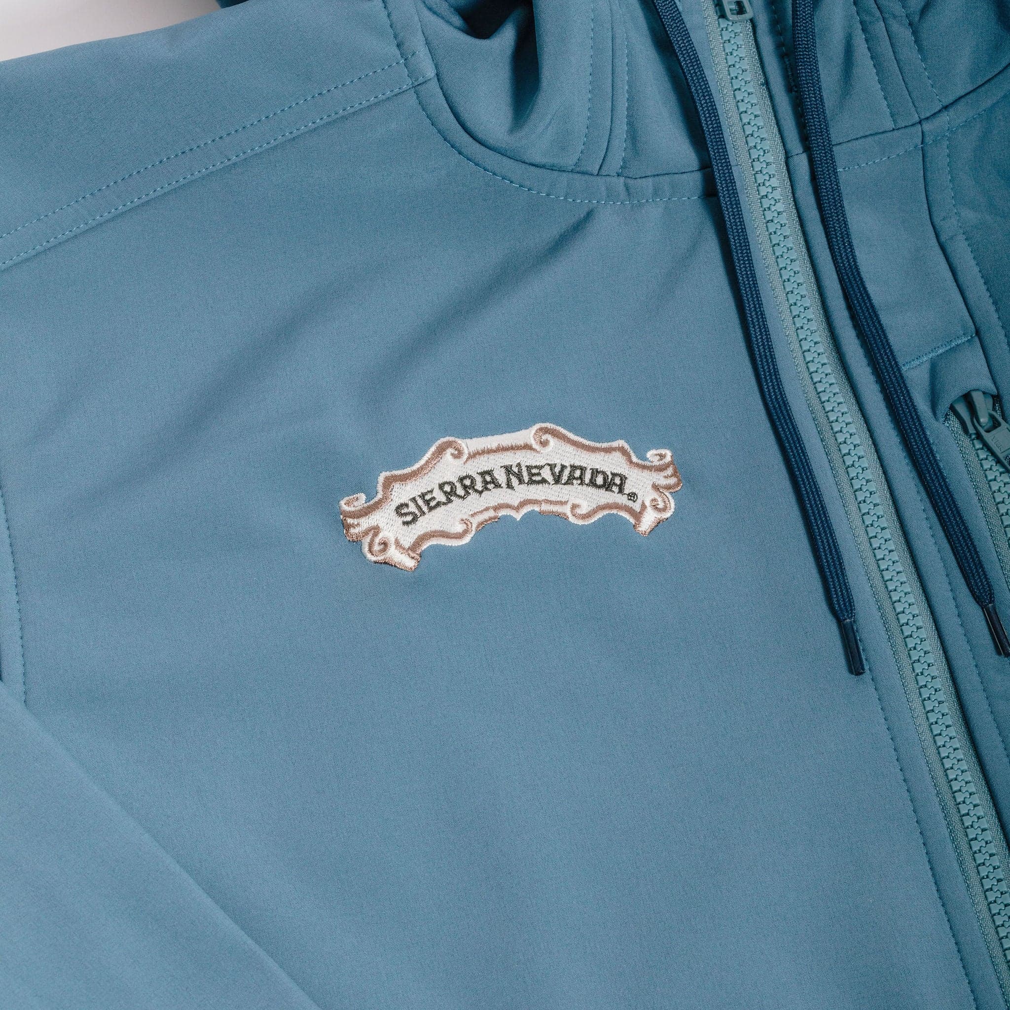 Sierra Nevada x Simms Rogue Fleece Hoody - detail of embroidered scroll logo