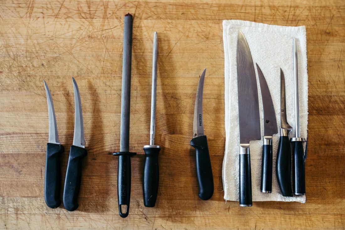 a set of knifes placed on a table