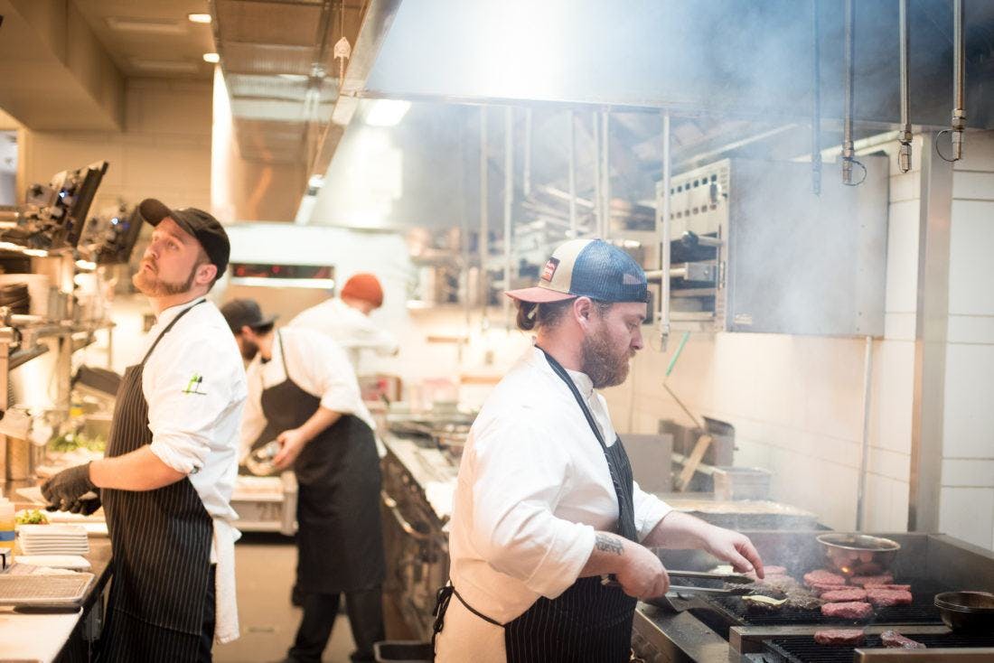 cooks preparing food in a busy kitchen