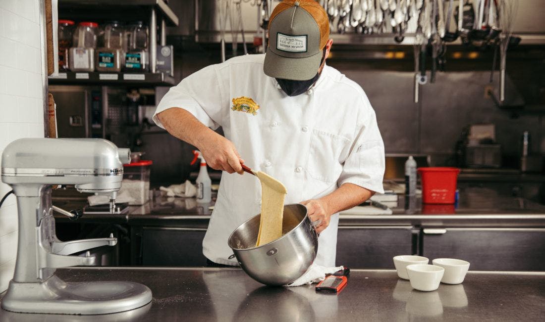 a cook mixing spaetzle