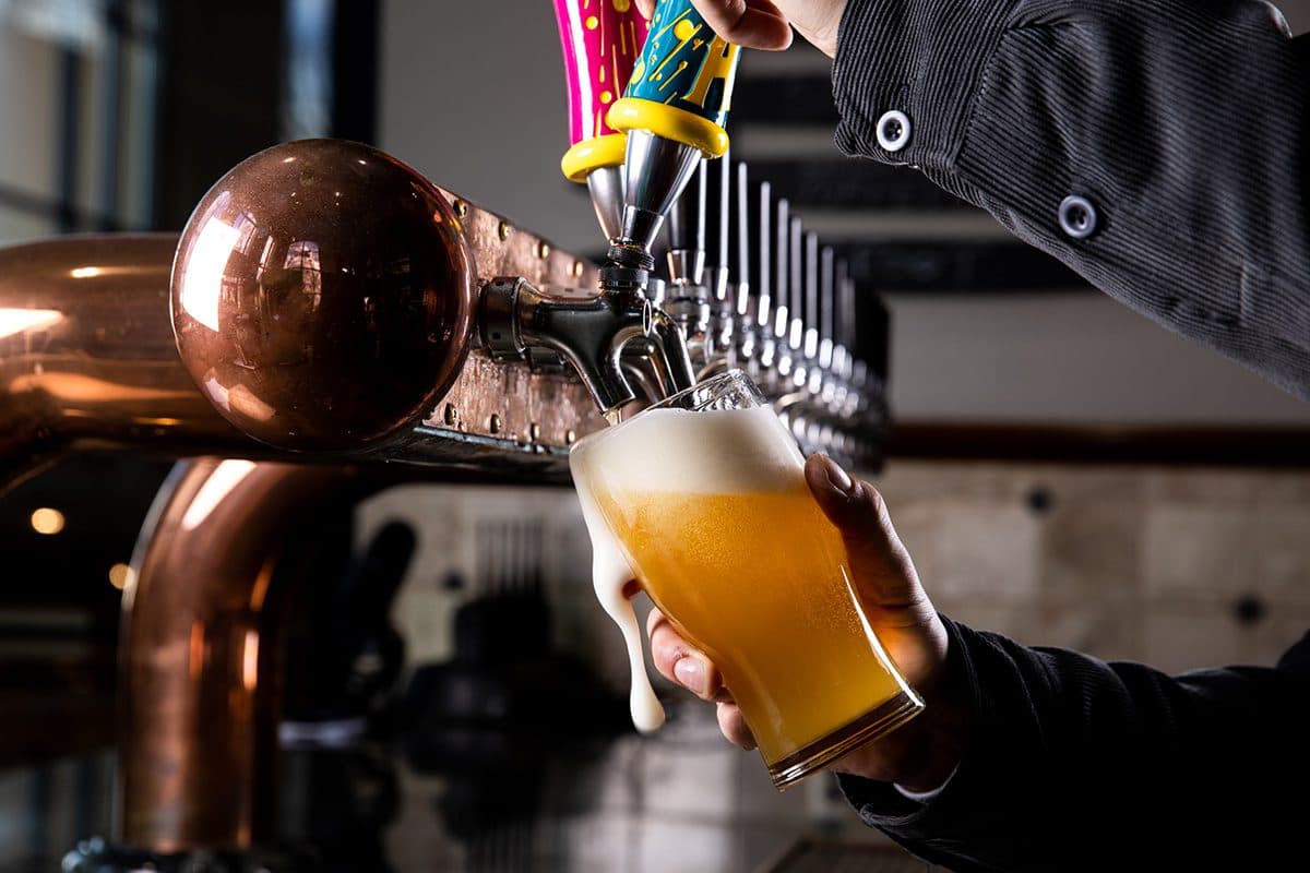 Bartender pouring Hazy Little Thing IPA into a glass