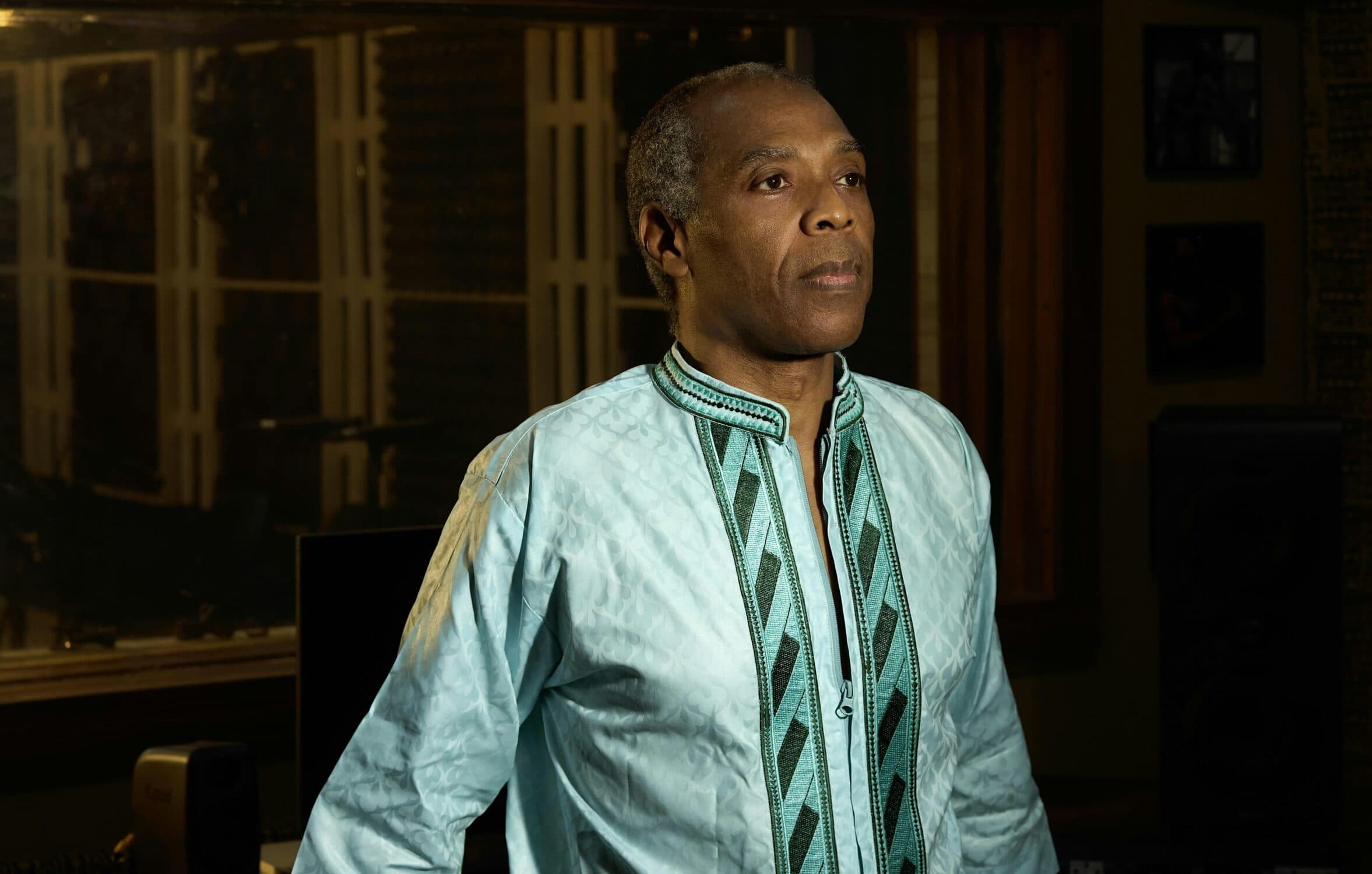Femi Kuti standing and looking away from the camera